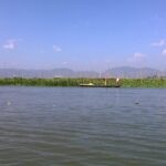 a man in a boat on a body of water