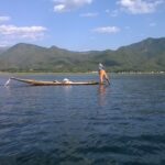 a man standing on a boat in the water